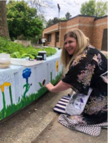 teacher contributing to the Shawmut Hills sycamore circle mural